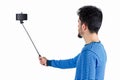Casual man using a selfie stick Royalty Free Stock Photo