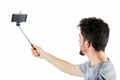 Casual man using a selfie stick Royalty Free Stock Photo
