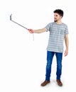 Casual man using a selfie stick Royalty Free Stock Photo