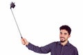 Casual man using a selfie stick Royalty Free Stock Photo