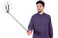 Casual man using a selfie stick Royalty Free Stock Photo