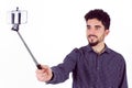 Casual man using a selfie stick Royalty Free Stock Photo