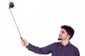 Casual man using a selfie stick Royalty Free Stock Photo