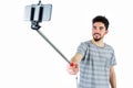 Casual man using a selfie stick Royalty Free Stock Photo
