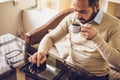 Casual Man Using Tablet Computer Sitting in Cafe Surfing Internet Royalty Free Stock Photo