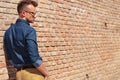 Casual man by wall back view Royalty Free Stock Photo