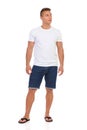 Casual Man In White T-shirt And Jeans Shorts Looking Away Royalty Free Stock Photo