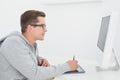 Casual man working at desk with computer and digitizer Royalty Free Stock Photo