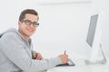 Casual man working at desk with computer and digitizer Royalty Free Stock Photo