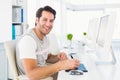 Casual man working at desk with computer and digitizer Royalty Free Stock Photo