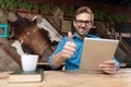 Casual man working on tablet while giving a thumbs up Royalty Free Stock Photo