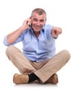 Casual middle aged man sits talks and points Royalty Free Stock Photo