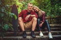 Casual moder young skateboarders couple posing on footway. Royalty Free Stock Photo