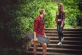 Casual moder young skateboarders couple posing on footway. Royalty Free Stock Photo