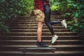 Casual moder young skateboarders couple posing on footway. Royalty Free Stock Photo