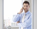 Casual office worker talking on mobile phone Royalty Free Stock Photo