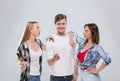 Casual People Group, Young Man Two Woman Happy Smile Handsome Guy Beautiful Girls Point Finger To You Talking Royalty Free Stock Photo