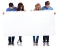 Casual people holding and looking at a blank board Royalty Free Stock Photo