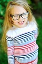 Casual portrait of sweet little girl wearing glasses