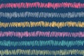 Casual repeat pattern of multicolored jagged stripes on dark blue backdrop hand drawn endless decorative vector texture of zigzag