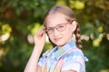 Casual schoolchildren. Little girl smile. Standind outdoor with eyeglasses. First grade