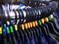 Casual Shirts on Hangers with Size Letter Labels on Curved Steel Rack