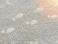 Casual shoes footsteps, Footprints in the sand at shine Royalty Free Stock Photo