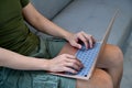 Casual sitting on couch and surfing in tenet with computer laptop. Royalty Free Stock Photo