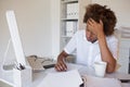 Casual stressed businessman writing at his desk Royalty Free Stock Photo