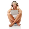 Casual student listening to music on the computer Royalty Free Stock Photo