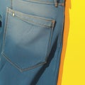 Casual style Blue jeans back pockets on a vibrant yellow