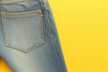 Casual style Blue jeans back pockets on a vibrant yellow