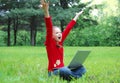 Casual success girl on a laptop in a green grass Royalty Free Stock Photo