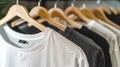 Assorted T-shirts on Hangers Displayed in a Row. Fashion Retail Concept. Casual Clothing Shopping. Modern Apparel Store Royalty Free Stock Photo