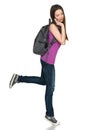 Casual teen girl wearing backpack talking on cell phone Royalty Free Stock Photo