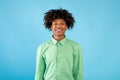 Casual teenage model. Portrait of smiling african american guy looking at camera over blue background Royalty Free Stock Photo