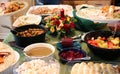 Casual Thanksgiving Feast on Table with Plates Being Filled Royalty Free Stock Photo