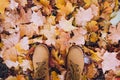 Casual unisex boots with autumn fallen leaves Royalty Free Stock Photo