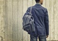 Man in blue suit and jeans with leather backpack Royalty Free Stock Photo