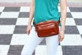 Casual weared women with big leather weist bag on black and whit