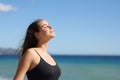 Casual woman breathing fresh air on the beach