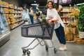 Casual woman grocery shopping and looking happy Royalty Free Stock Photo