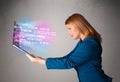 Casual woman holding laptop with exploding data and numers Royalty Free Stock Photo