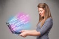 Casual woman holding laptop with exploding data and numers Royalty Free Stock Photo