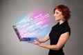 Casual woman holding laptop with exploding data and numers Royalty Free Stock Photo