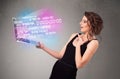 Casual woman holding laptop with exploding data and numers Royalty Free Stock Photo