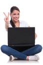 Casual woman sits with laptop & victory Royalty Free Stock Photo