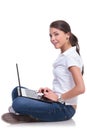 Casual woman sits & works on laptop Royalty Free Stock Photo