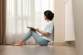 woman sitting on the floor and working on laptop at home Royalty Free Stock Photo