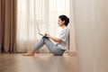 woman sitting on the floor and working on laptop at home Royalty Free Stock Photo